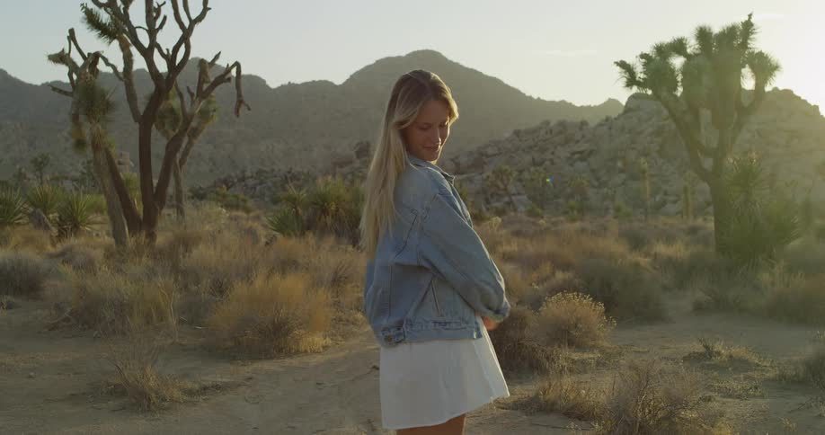 The woman is posing in the desert