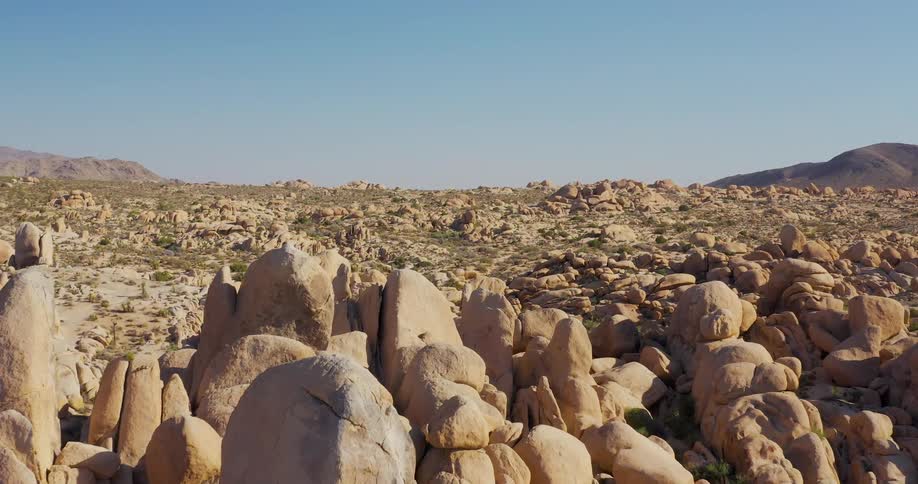 Rock formations scattered across the desert under a clear sky
