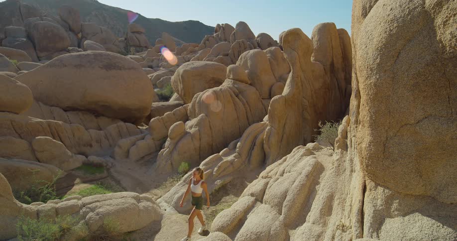 Explorer walks among rocky formations in the desert