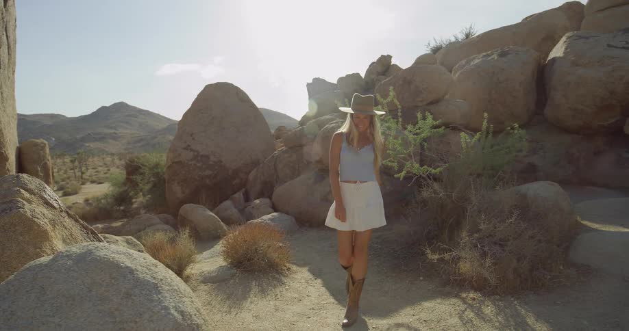Woman explores sunny desert rock formations