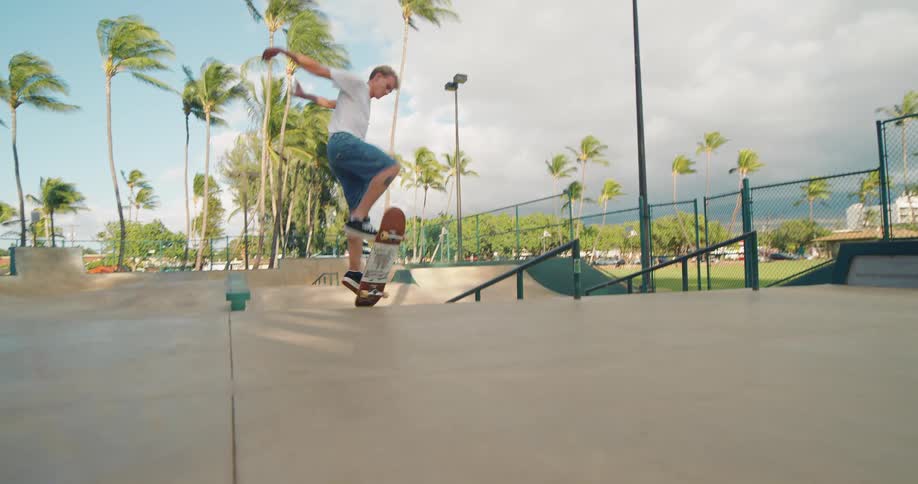 The man jumps high on his skateboard