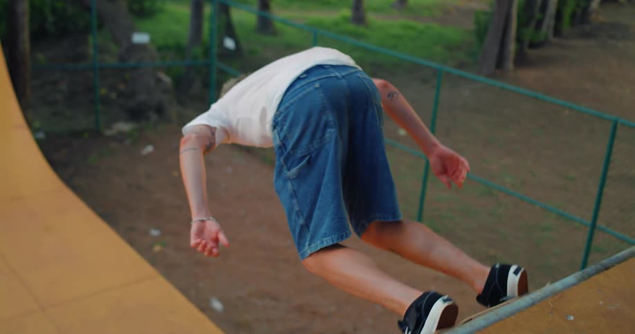 Young man skateboards on an outdoor wooden ramp