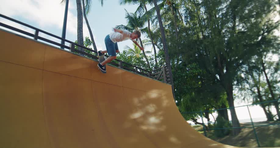 Skater drops in on a wooden halfpipe