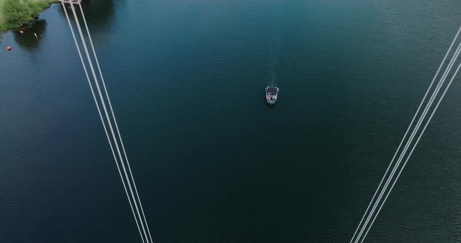 The boat is traveling towards the bridge