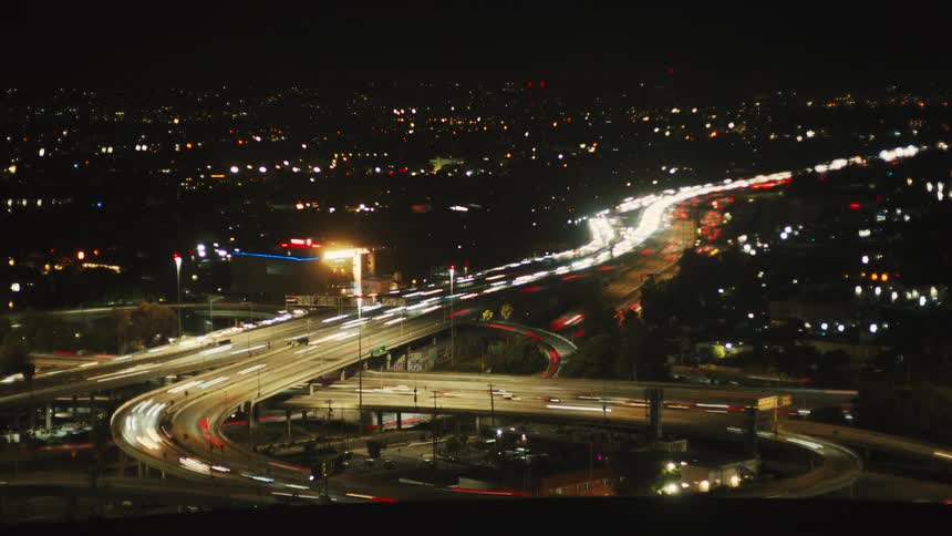 Time lapse of commuters commuting on a freeway at night