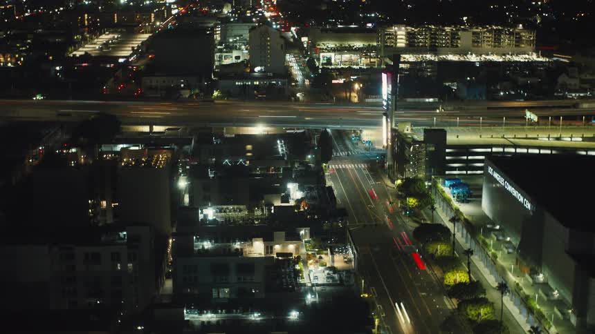Aerial view of a city at night with illuminated streets and buildings