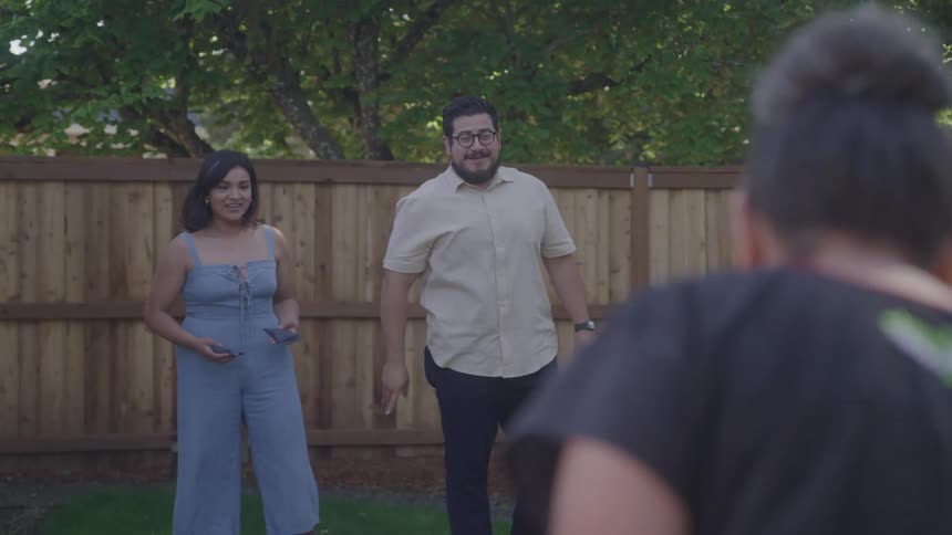Friends share a relaxed backyard moment during a sunny gettogether