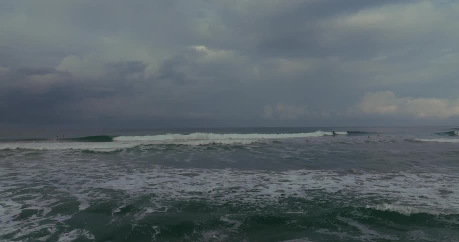 Rough sea under cloudy sky with waves spreading across the horizon