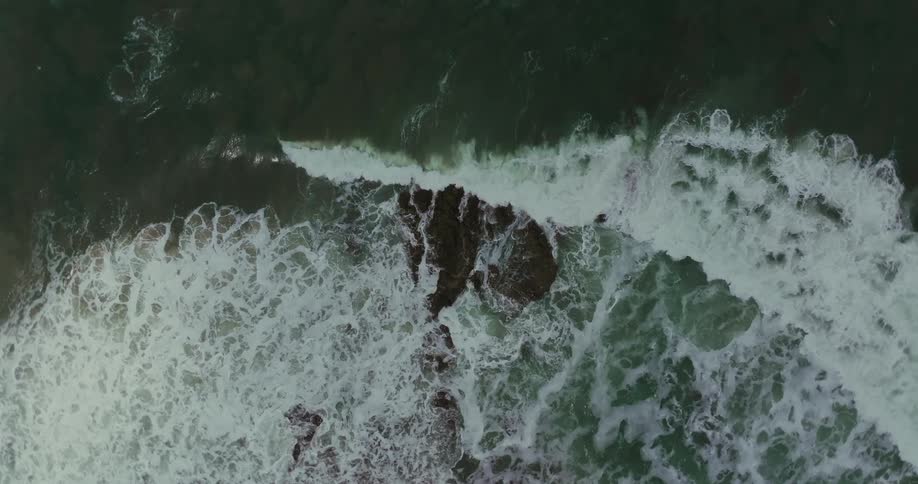 Waves crash on the rocks of the shore