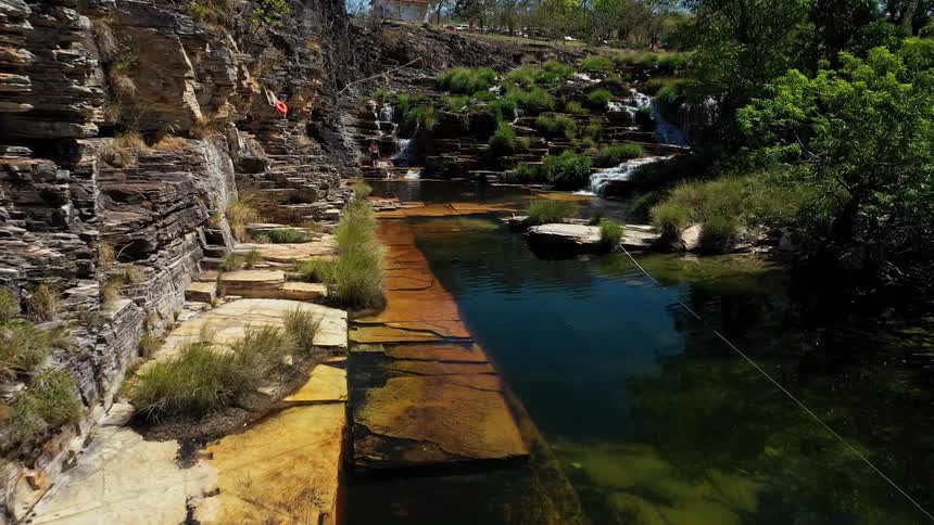 A stream flowing through a rocky terrain at midday
