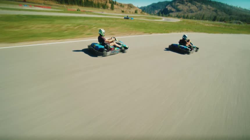 A kart trying to overtake another on a racing track