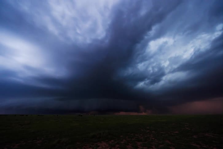 Stormy weather with lightning visible beyond the dark clouds