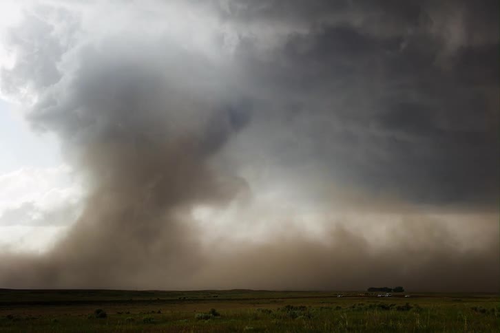 A tornado begins to form over a field