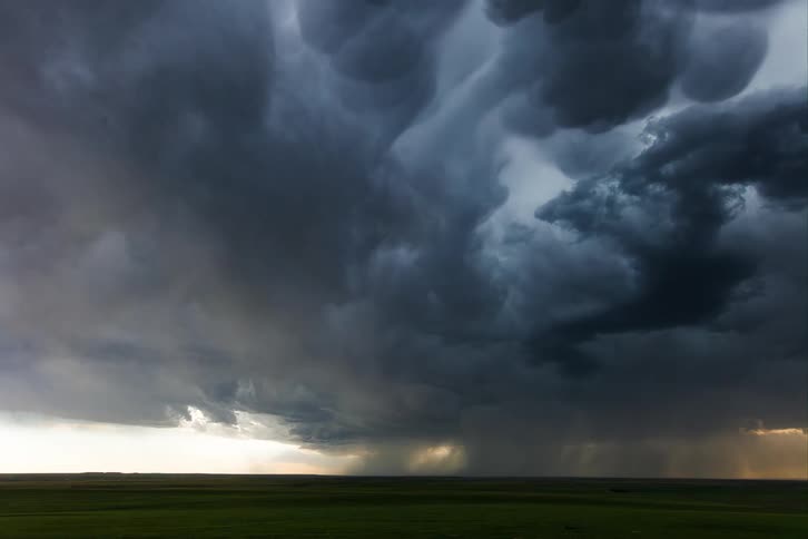 Ominous dark blue storm clouds move slowly in the sky