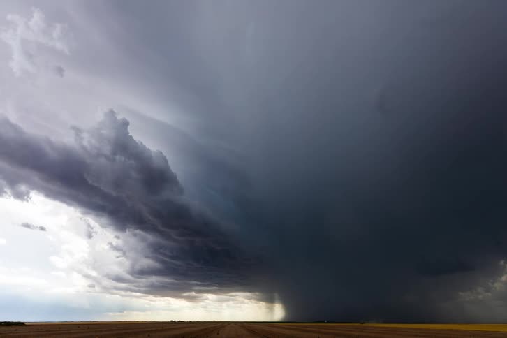 A time lapse of large gray storm clouds moving across the sky
