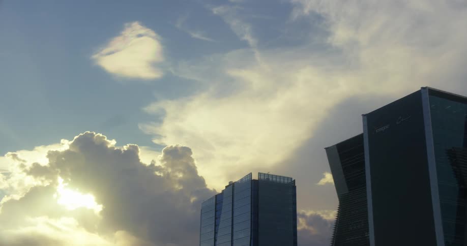 Tall modern buildings beneath a glowing evening sky