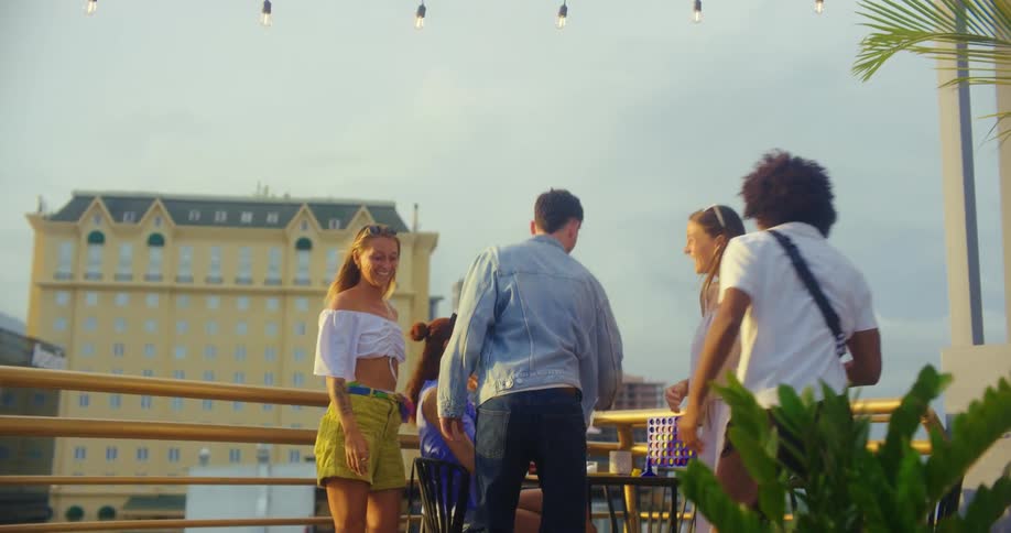 Friends talk and have drinks on the roof