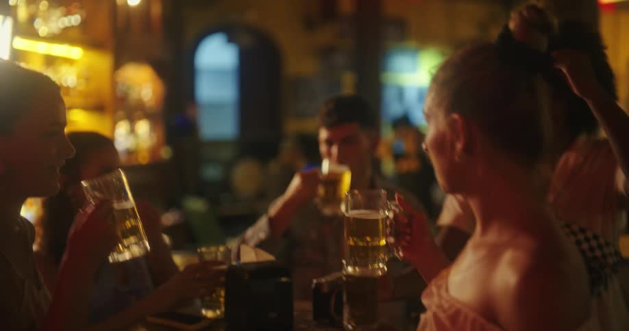 Friends take a selfie while enjoying drinks at a lively bar