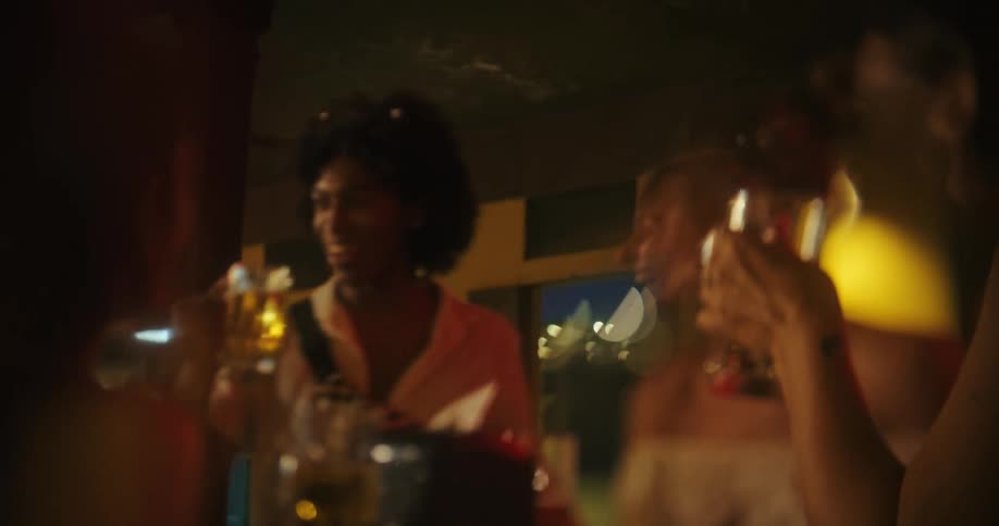 A group of friends having fun drinking beer together in a caf at night