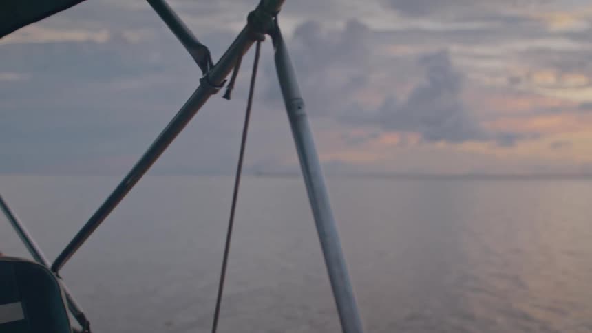 Boat traveling over the sea oudoors during dusk or dawn