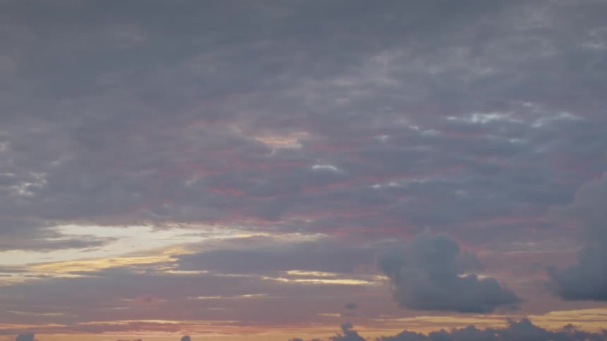The sun is rising on a cloudy day