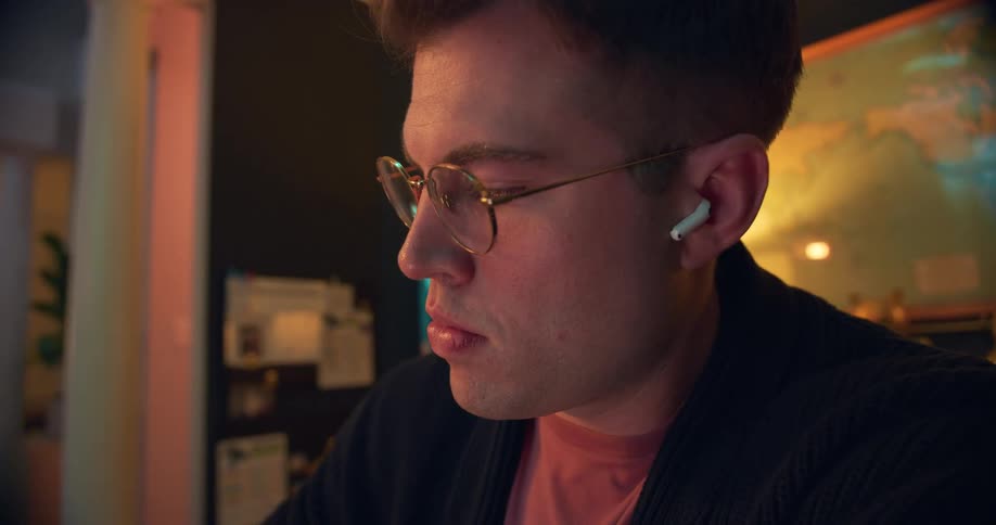 The man is examining something at home