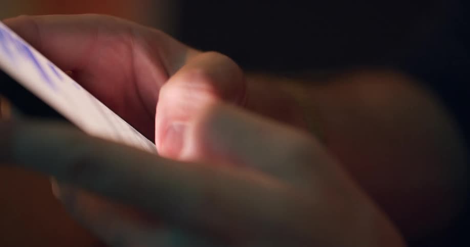 Pair of hands typing on a smartphone