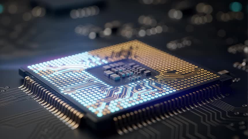A glowing microchip rests on a circuit board under dim light