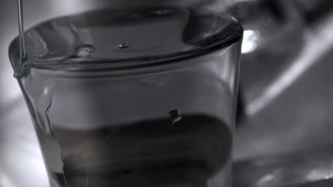 The glass is overfilled with water