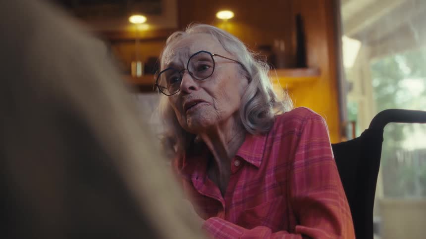 A woman in a wheelchair talks with a man