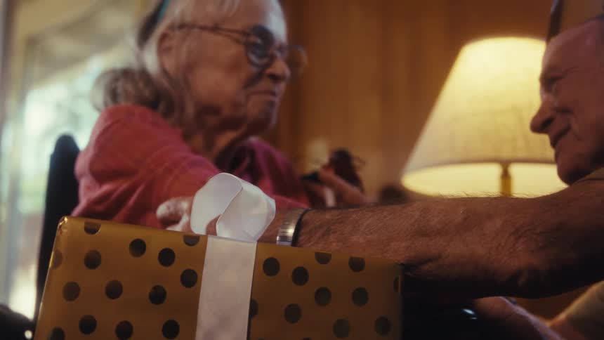 Elderly lady talking warmly and cheerfully with an elderly man in a room