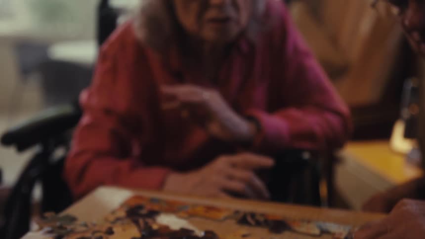 A man and woman do a jigsaw puzzle together
