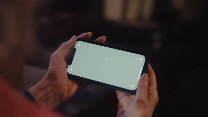 The screen of a cell phone that is in a persons hand in a static white image