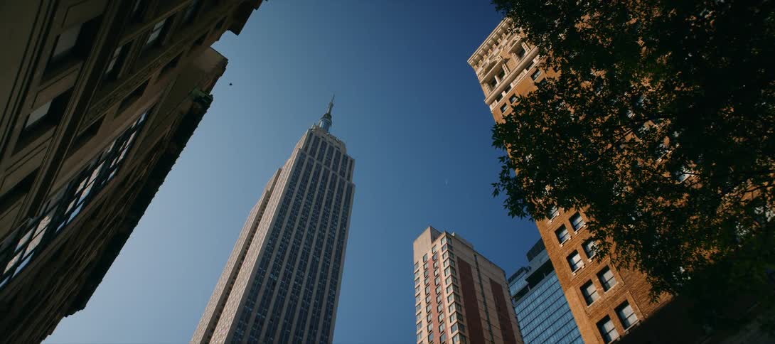 Low angle view of tall city skyscrapers against a clear blue sky