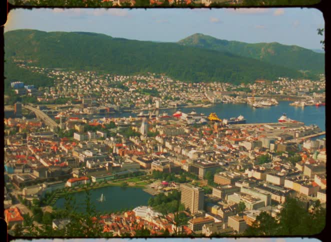 Coastal city surrounded by water and hills outdoors during day time