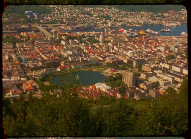 Panoramic view of city surrounded by mountains and lake