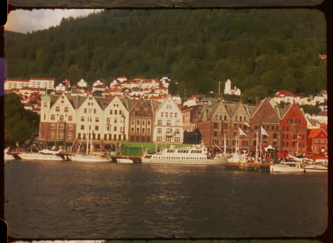 Colorful historic buildings along a harbor with docked boats