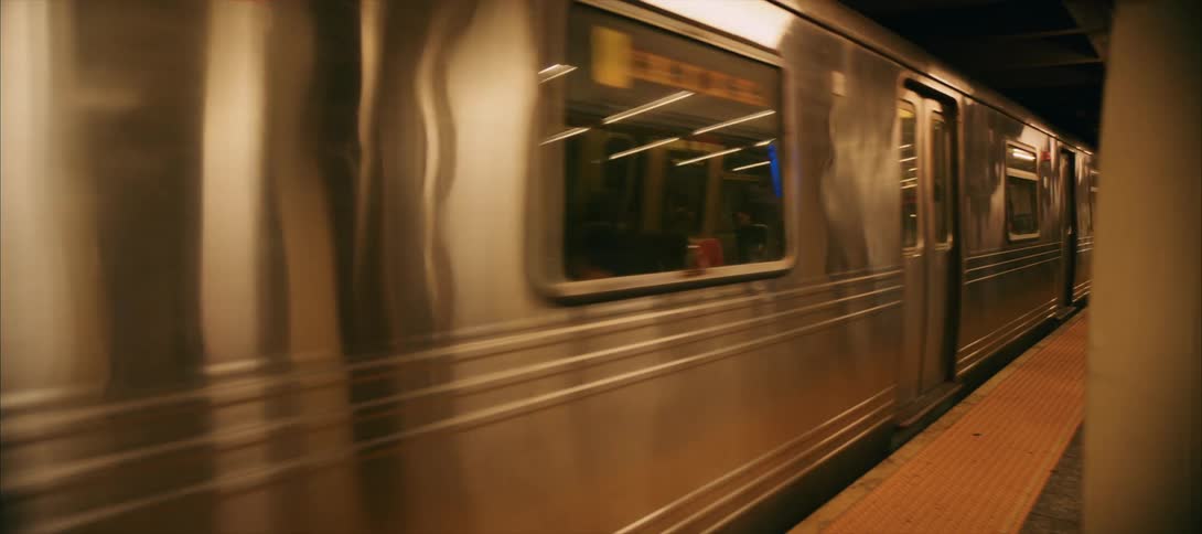 N line subway train arriving at an underground station