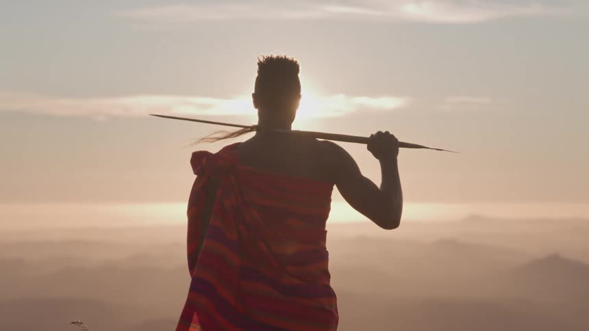 The man has a spear on his shoulder