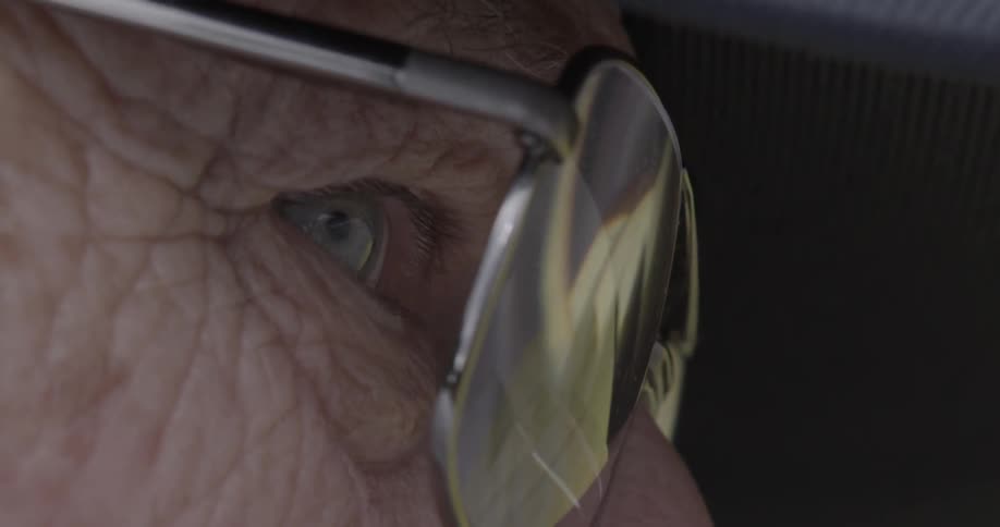 An elderly man is wearing eyeglasses