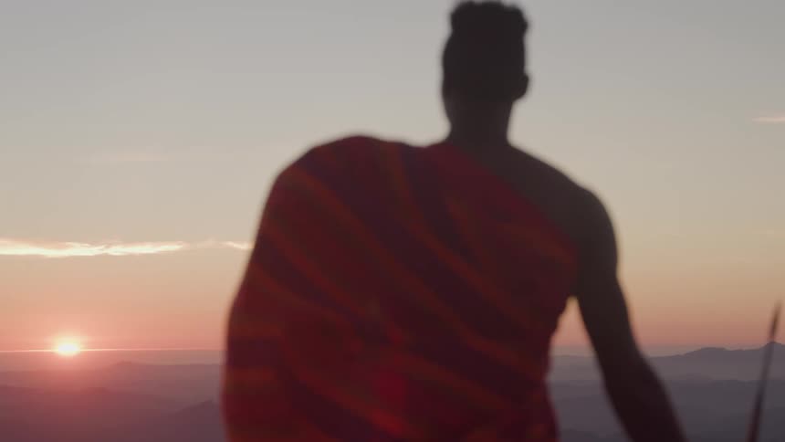 The man is watching the sun rise