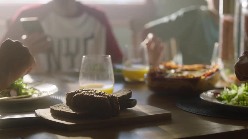 Family eats a meal together during the daytime