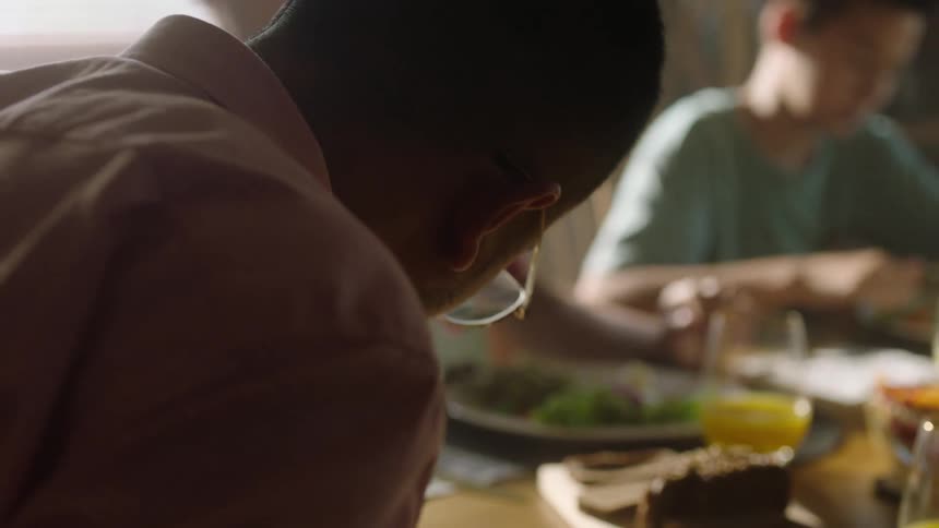 A man eats with his children