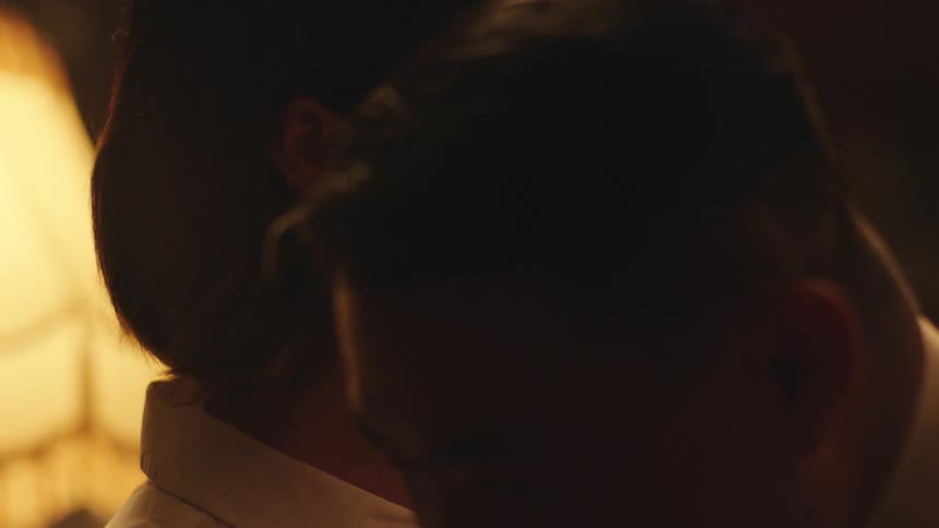 A couple hugging and smiling at each other in a club at night