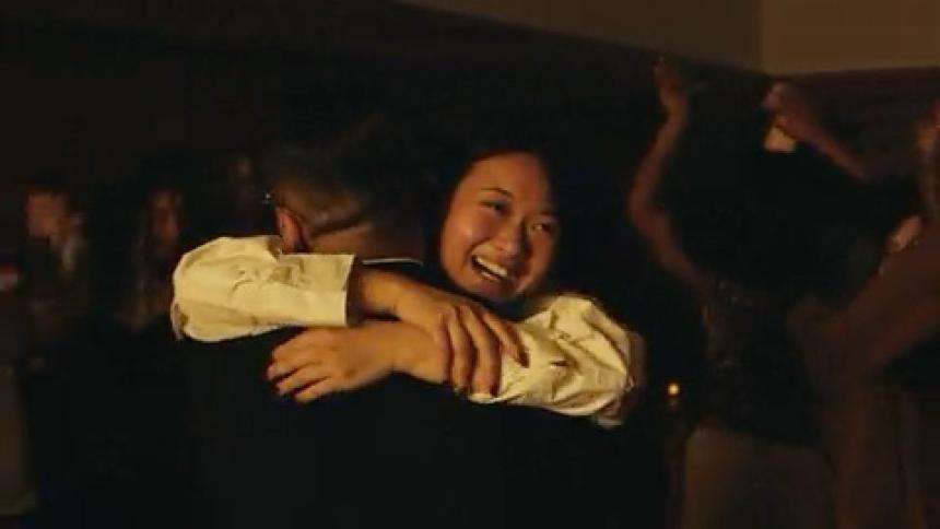 A group of friends dancing with their partners on a stage at night