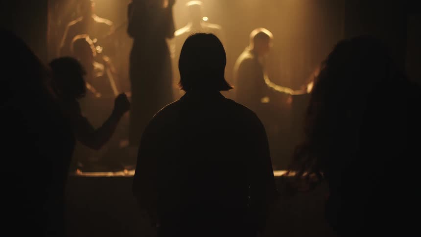 People are dancing and listening to live music in the club