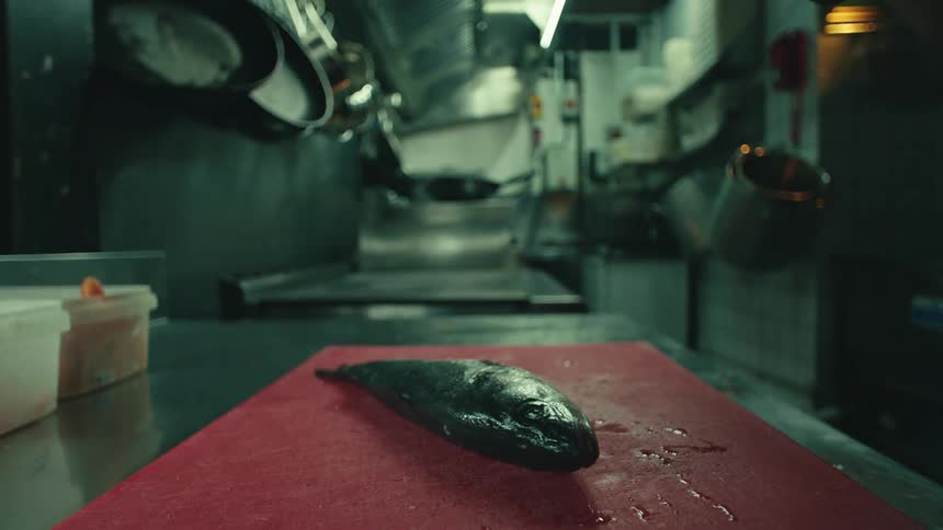 The fish is cut with a large blade