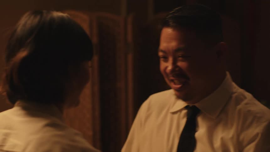Young adult male and female dancing and lauching indoors during night time by candlelight