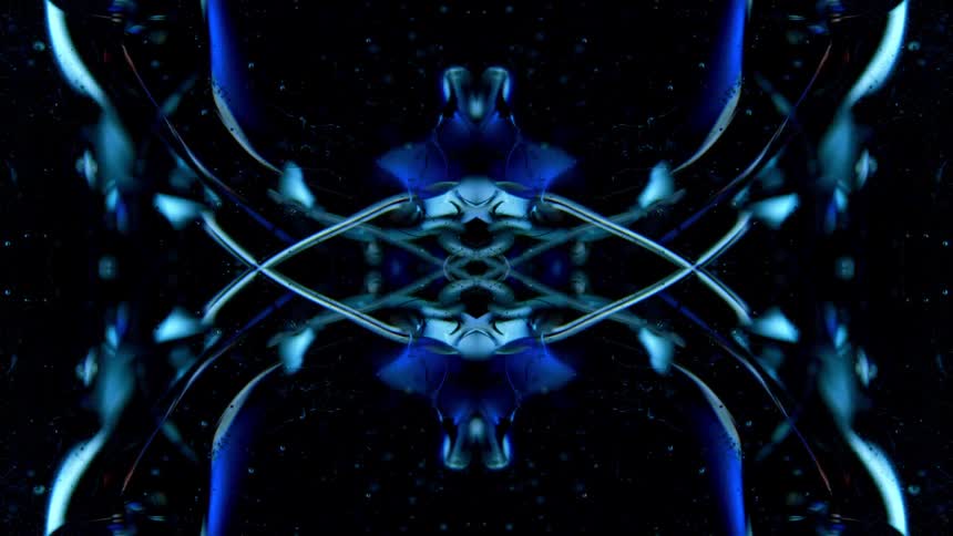 A blue fluid substance moves and changes shape in a symmetrical pattern on a black background occasionally revealing subtle orange and yellow reflections