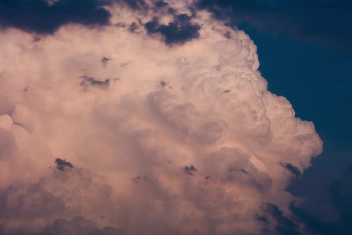 Large storm clouds grow and move
